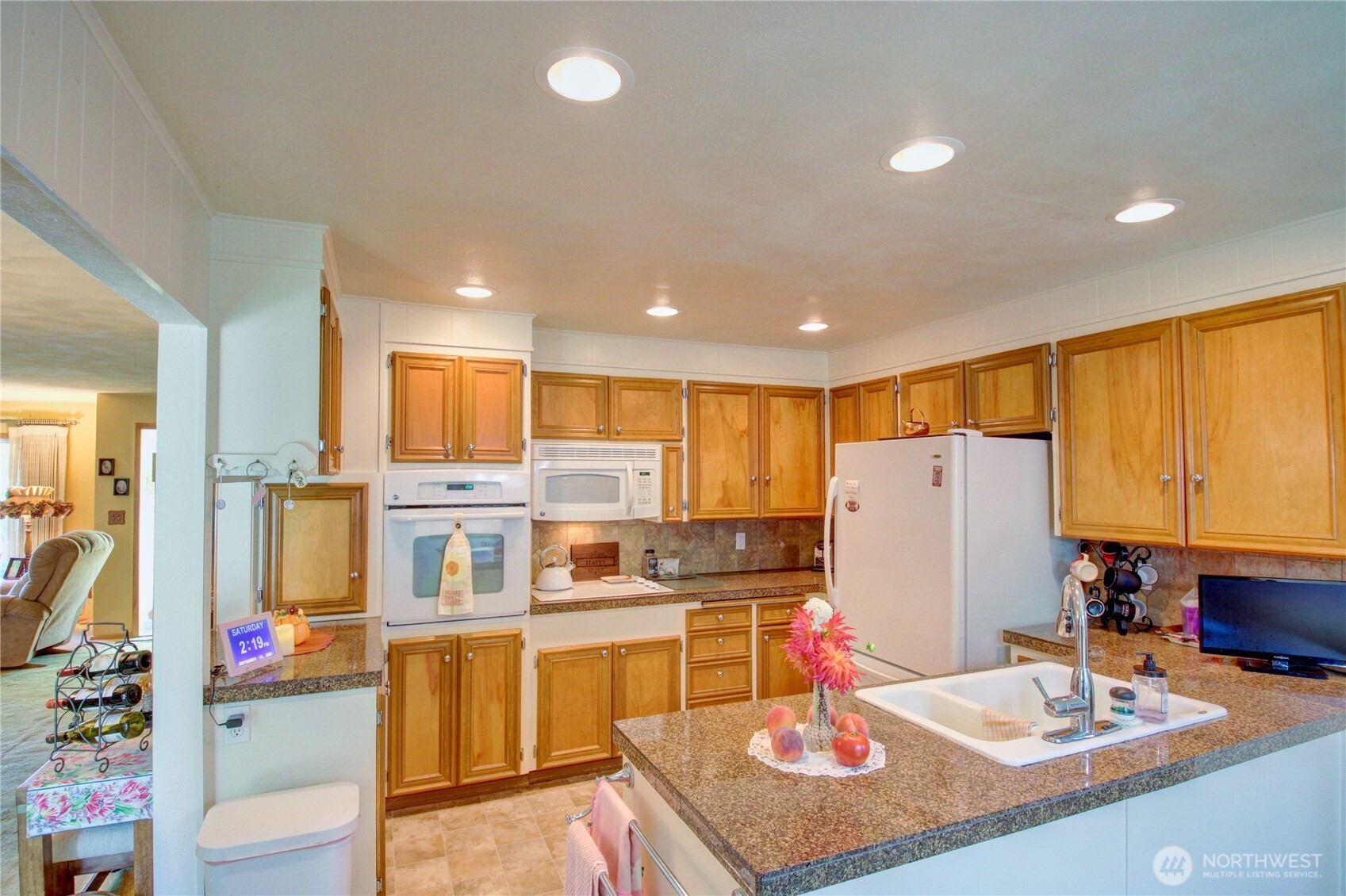 2310 Alison Avenue Mount Vernon, WA 98273 - Photo 12 of 39 a kitchen with stainless steel appliances kitchen island granite countertop a refrigerator and a stove