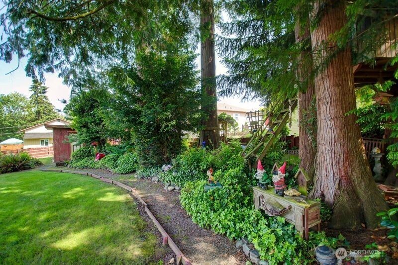 2310 Alison Avenue Mount Vernon, WA 98273 - Photo 37 of 39 a view of a garden with plants and large trees