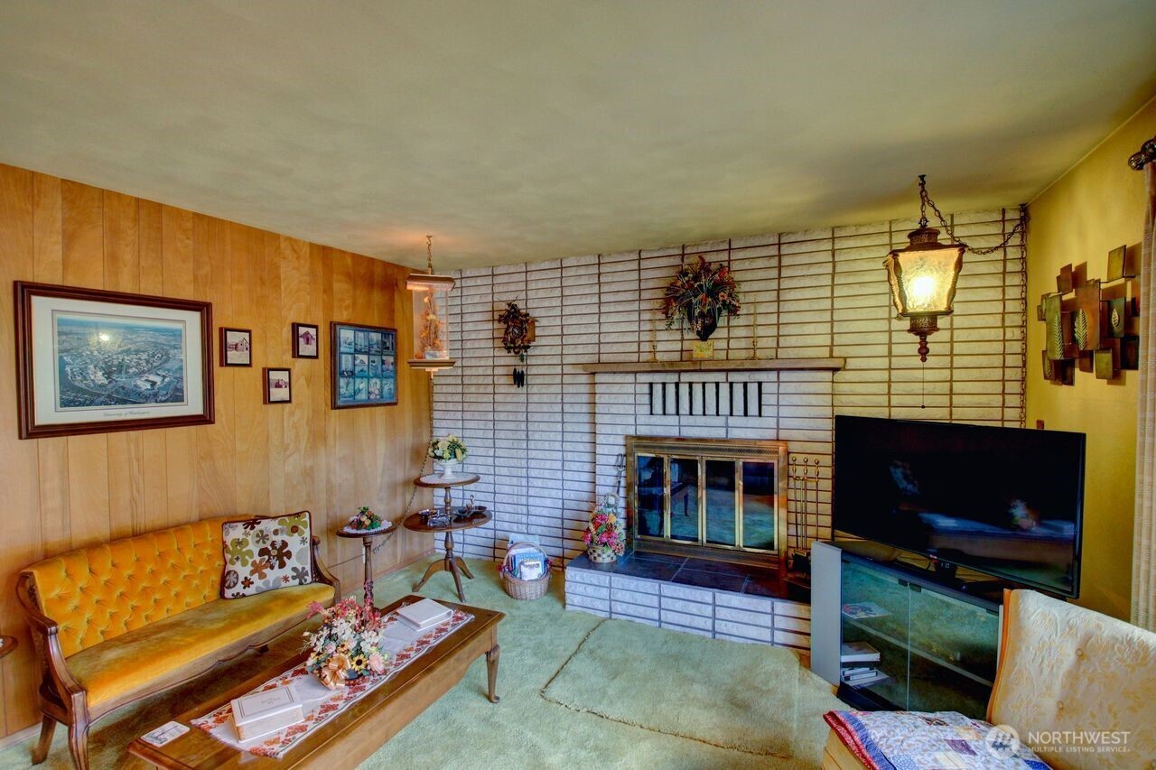 2310 Alison Avenue Mount Vernon, WA 98273 - Photo 6 of 39 a living room with furniture a flat screen tv and a fireplace