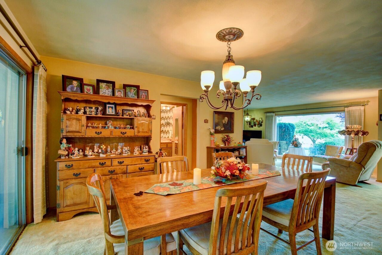 2310 Alison Avenue Mount Vernon, WA 98273 - Photo 8 of 39 a view of a dining room with furniture a chandelier and wooden floor