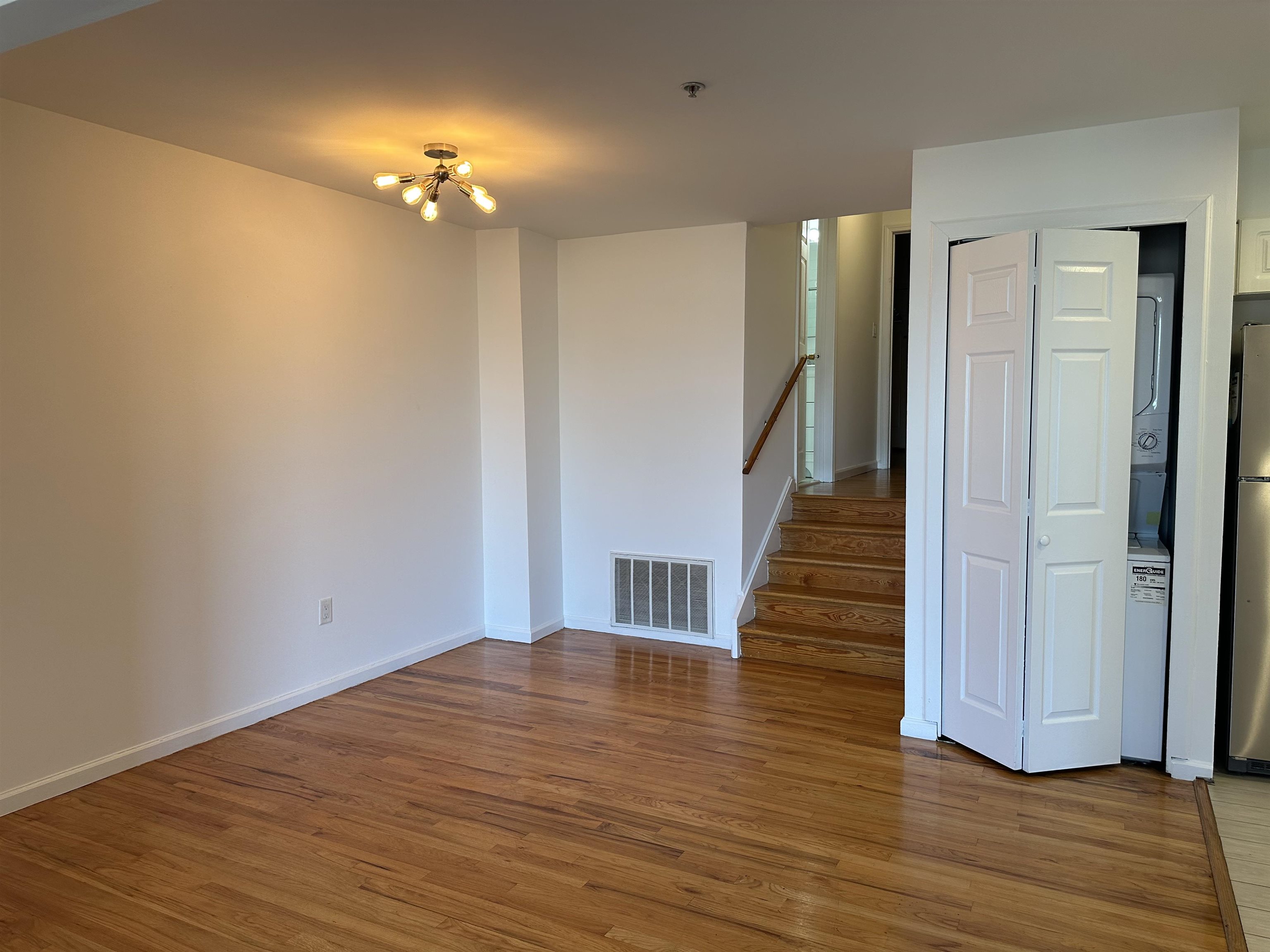 8911 Riverside Place, Unit 1 North Bergen, NJ 07047 - Photo 9 of 18 a view of a hallway with wooden floor and stairs