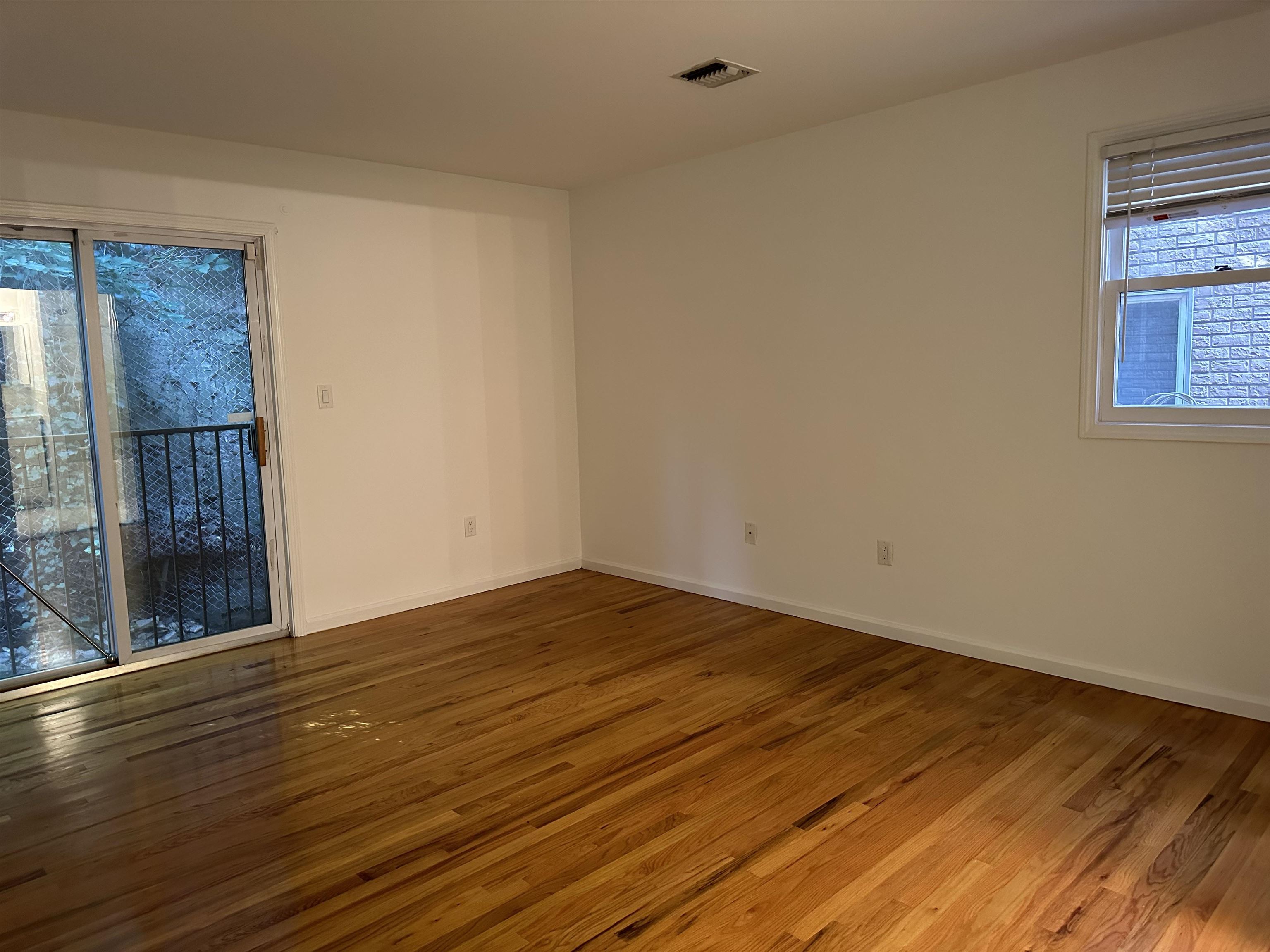 8911 Riverside Place, Unit 1 North Bergen, NJ 07047 - Photo 10 of 18 a view of empty room with wooden floor and fan
