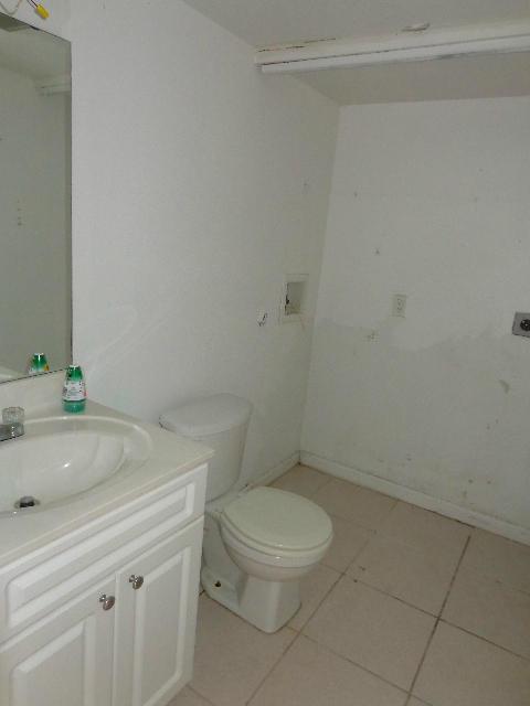 8117 Severn Drive, Unit C Boca Raton, FL 33433 - Photo 8 of 16 1st floor bathroom and laundry closet