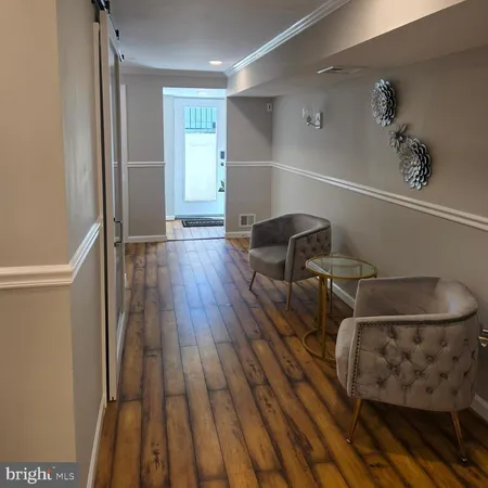 a room with wooden floor and furniture