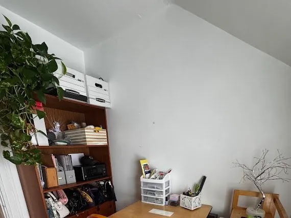 a view of workspace with wooden floor and room