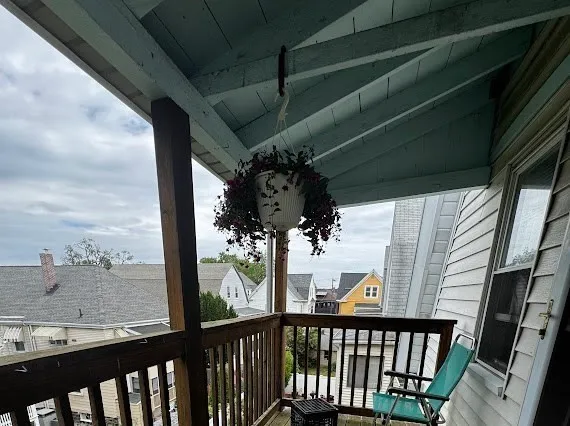 a view of a balcony with wooden floor