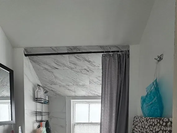 a bathroom with a shower and a mirror