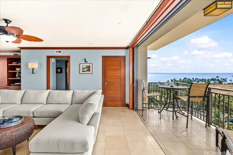 a living room with furniture a rug and a large window