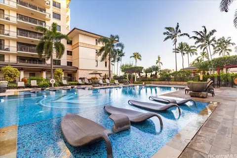 a view of a swimming pool with outdoor seating