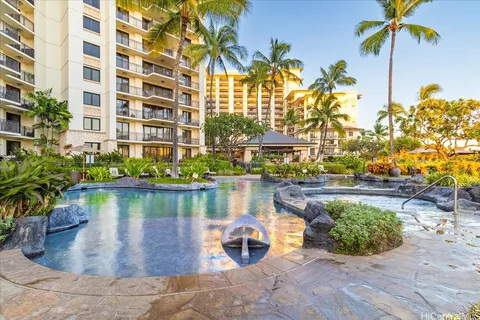 a front view of a house with swimming pool having outdoor seating