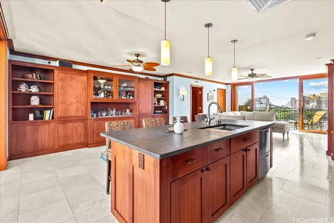 a kitchen with stainless steel appliances granite countertop a stove a sink and a wooden cabinets