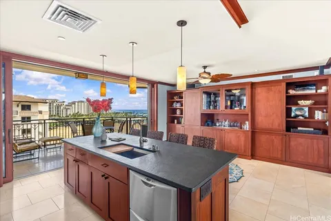a kitchen with stainless steel appliances granite countertop a sink and a wooden cabinets
