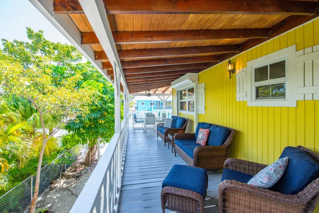 a balcony with furniture and wooden floor