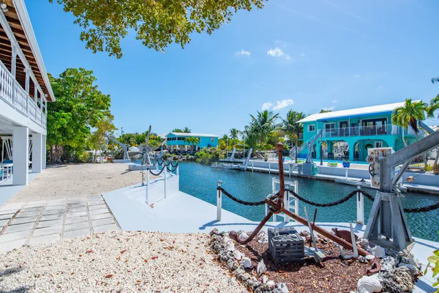 a swimming pool with outdoor seating and plants