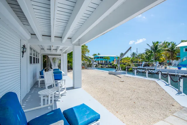 a view of a patio with table and chairs potted plants with wooden floor