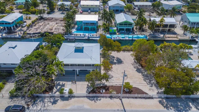 an aerial view of a house with garden space and lake view