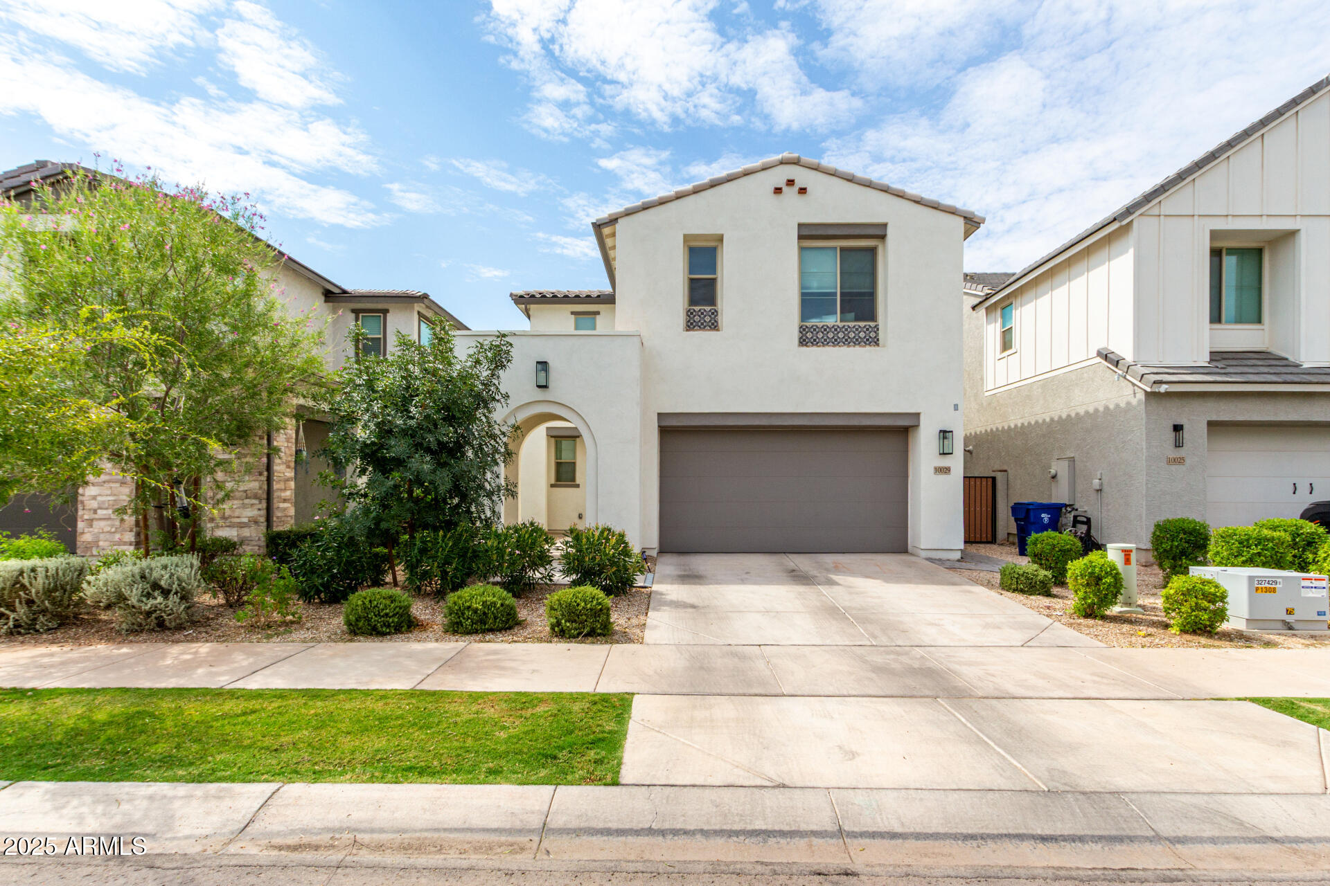 10029 East Tahoe Avenue Mesa, AZ 85212 - Photo 1 of 52 a front view of a house with a yard and potted plants