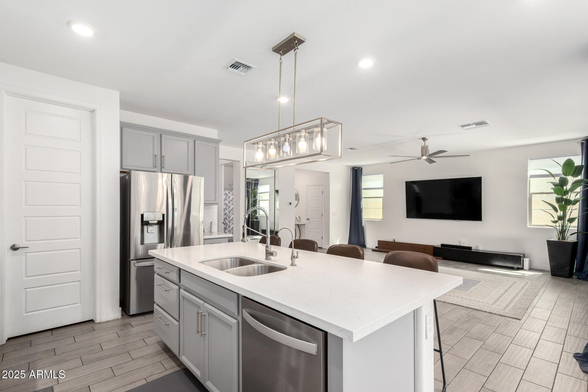 10029 East Tahoe Avenue Mesa, AZ 85212 - Photo 14 of 52 a kitchen with stainless steel appliances a stove a sink and a refrigerator