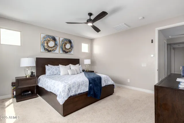 a bedroom with a bed and a chandelier