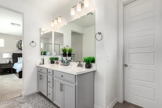a bathroom with a sink vanity and mirror