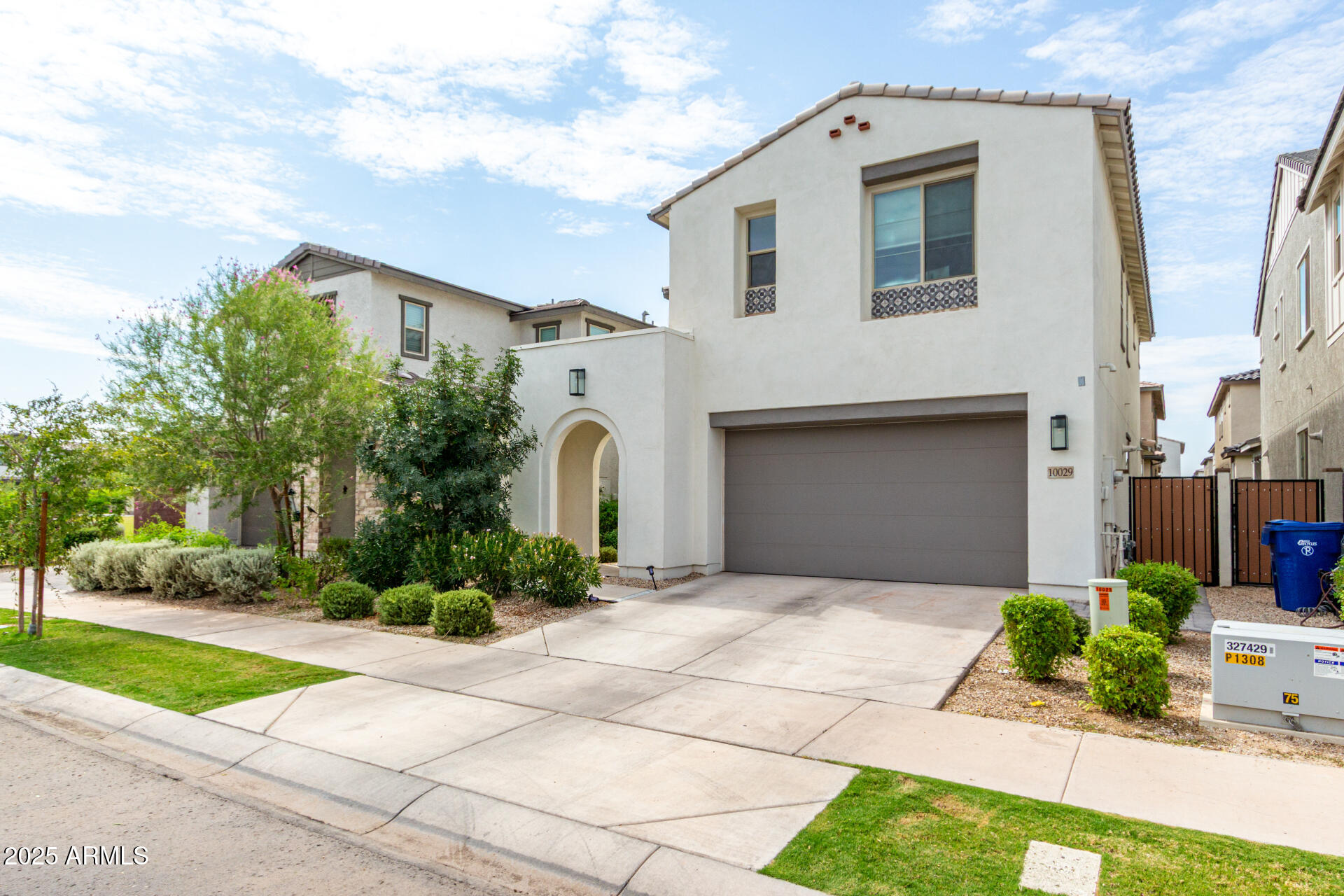 10029 East Tahoe Avenue Mesa, AZ 85212 - Photo 2 of 52 a front view of a house with a garden and garage