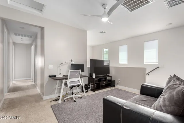 a view of a livingroom with workspace and a couch