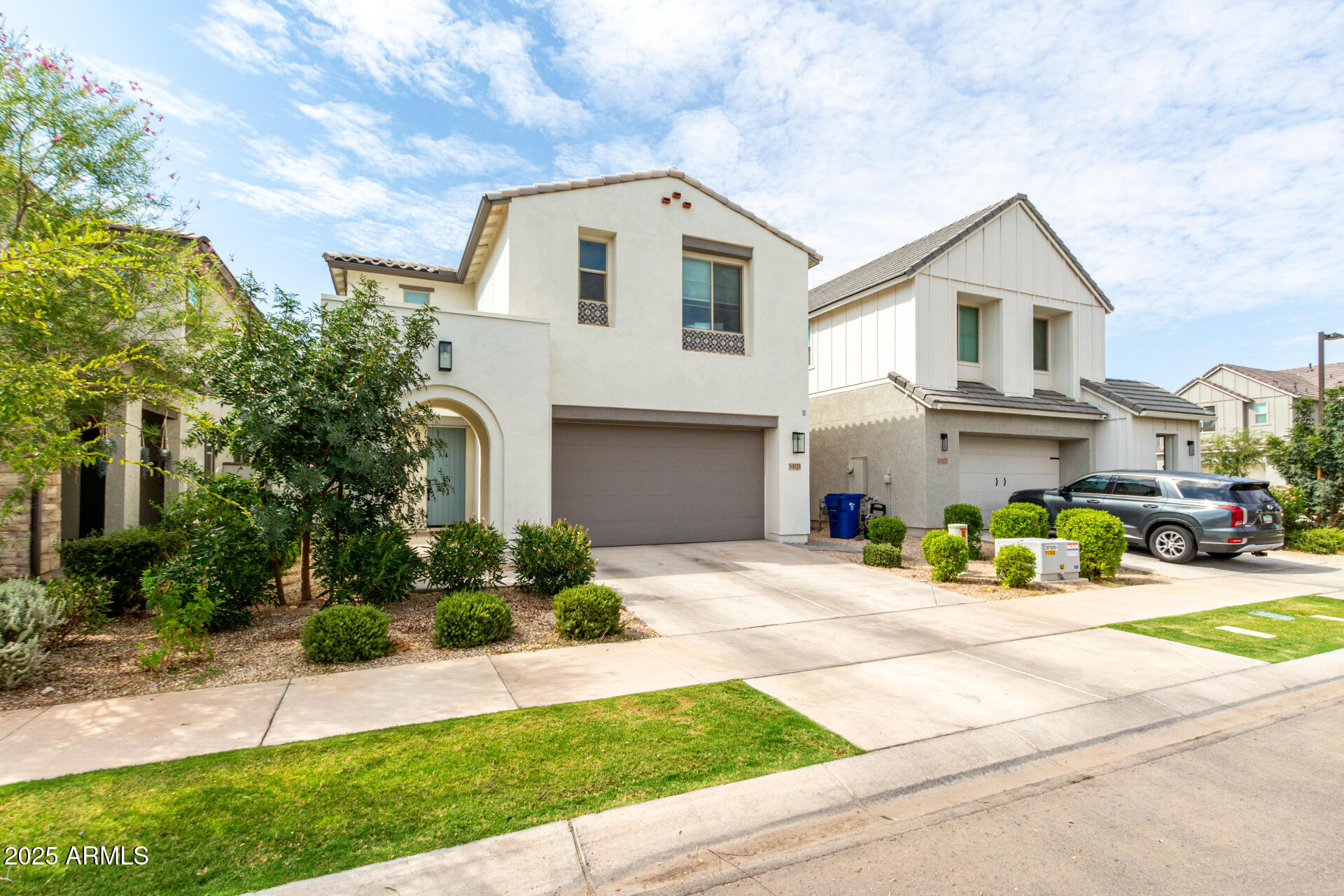 10029 East Tahoe Avenue Mesa, AZ 85212 - Photo 4 of 52 a front view of a house with yellow lighting
