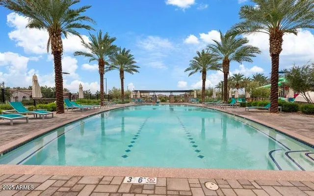 a swimming pool with outdoor seating and yard