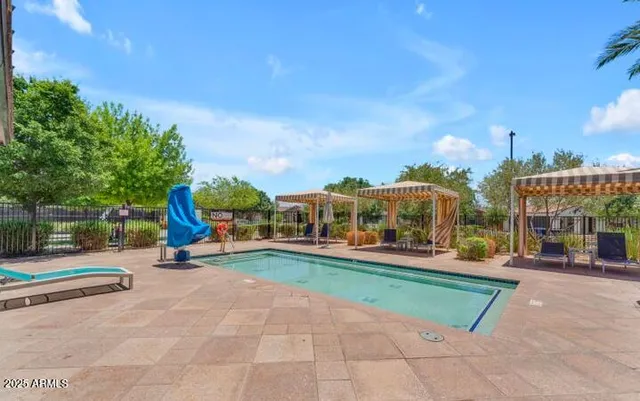 a view of a backyard with a swimming pool