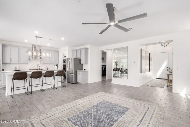 a living room with furniture and kitchen view