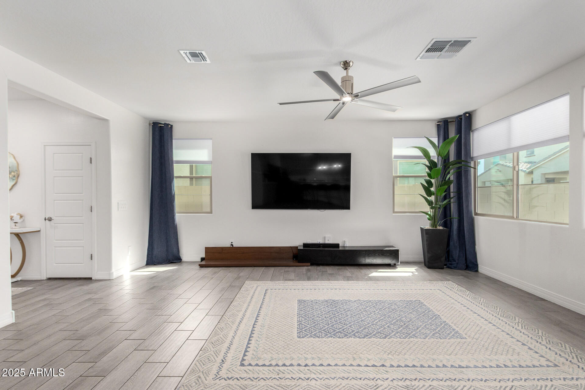 10029 East Tahoe Avenue Mesa, AZ 85212 - Photo 9 of 52 a living room with furniture and a flat screen tv