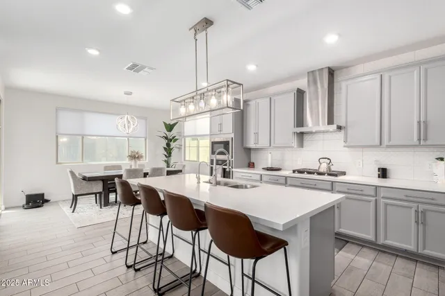 a kitchen with a sink a counter space appliances and cabinets