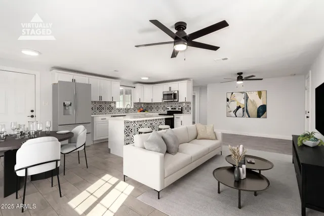 a living room with furniture and a view of kitchen