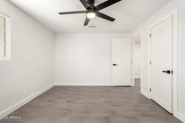 a view of a room with a ceiling fan