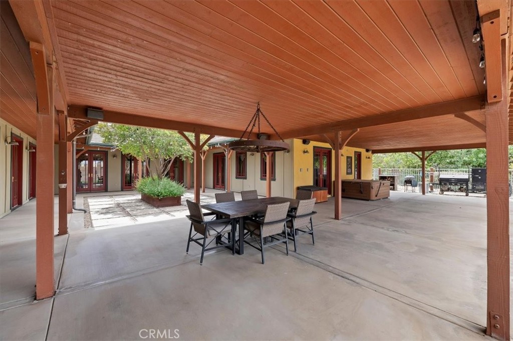 16420 Rocky Glen Road Perris, CA 92570 - Photo 49 of 74 a view of a patio with table and chairs under an umbrella