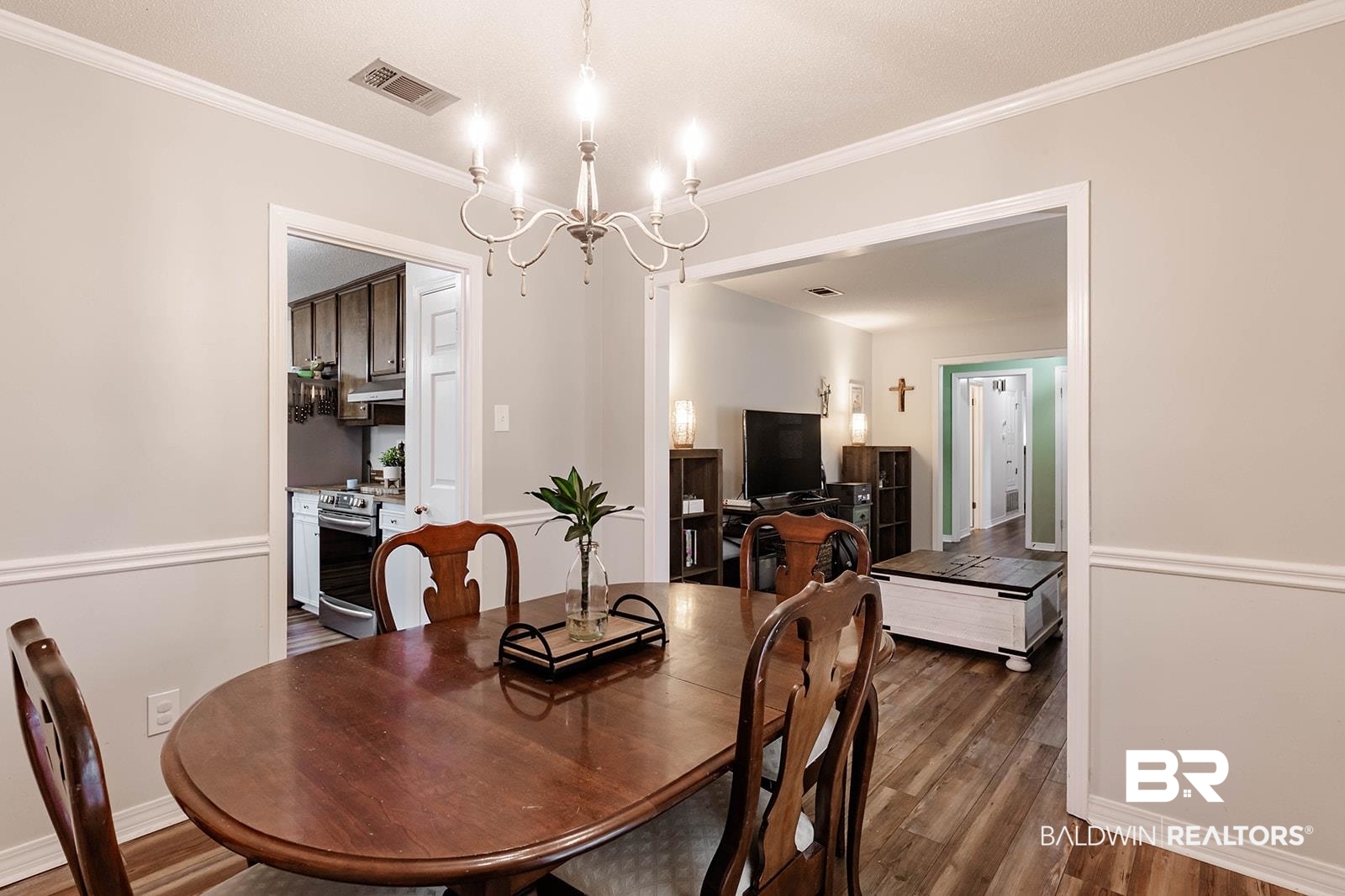 2920 Quail Creek Run Mobile, AL 36695 - Photo 16 of 33 Dining area with wood finished floors, crown molding, and a chandelier