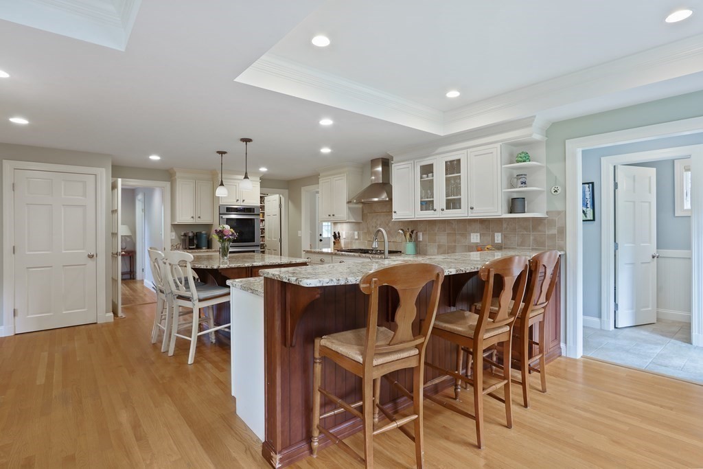 60 Colby Street Needham, MA 02492 - Photo 14 of 41 a kitchen with a dining table chairs and wooden floor