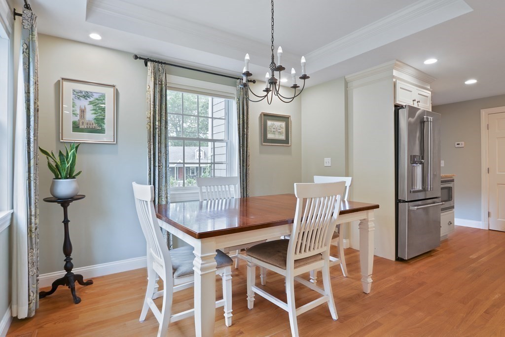 60 Colby Street Needham, MA 02492 - Photo 18 of 41 a view of a dining room with furniture a chandelier and wooden floor