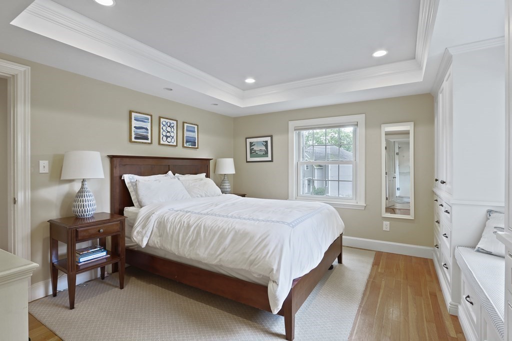 60 Colby Street Needham, MA 02492 - Photo 23 of 41 a large bedroom with a bed and wooden floor