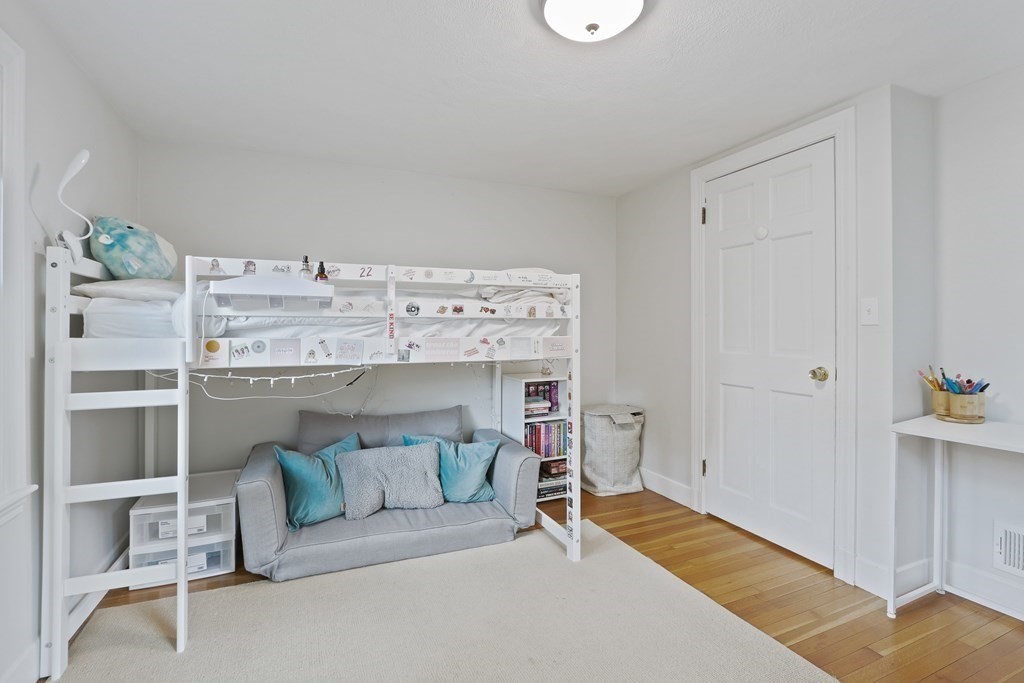 60 Colby Street Needham, MA 02492 - Photo 31 of 41 a living room with a couch and chandelier