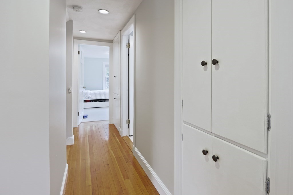 60 Colby Street Needham, MA 02492 - Photo 33 of 41 a view of a hallway with wooden floor and a bathroom