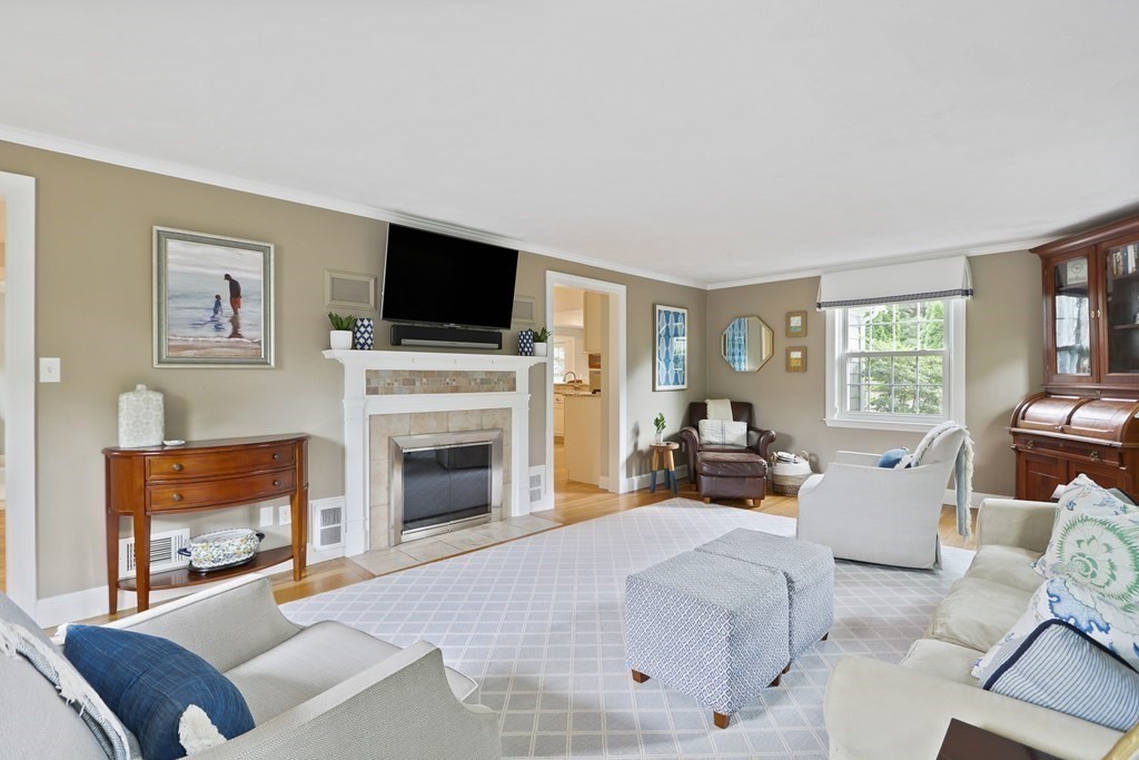 60 Colby Street Needham, MA 02492 - Photo 6 of 41 a living room with furniture a fireplace and a flat screen tv