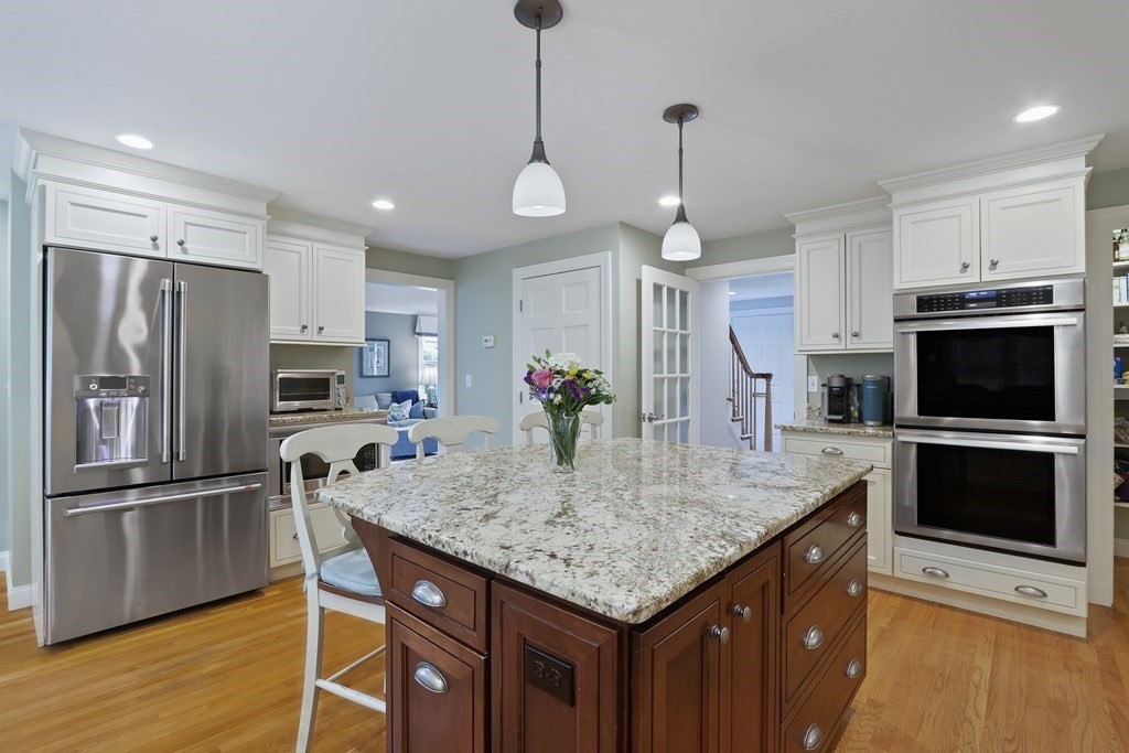 60 Colby Street Needham, MA 02492 - Photo 10 of 41 a kitchen with stainless steel appliances granite countertop a kitchen island a stove a refrigerator a oven and a sink with wooden floor