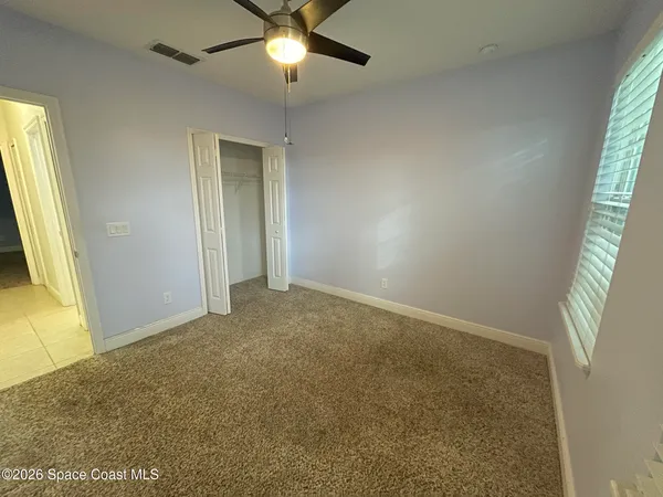 a view of an empty room and a window