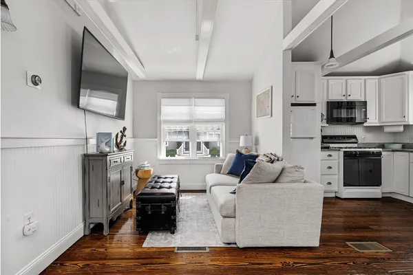 a view of a entryway with furniture and wooden floor