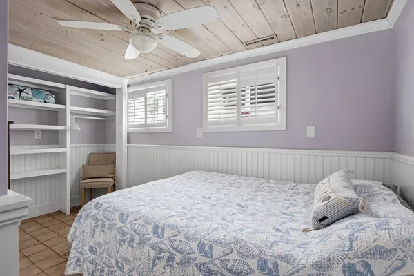 a bedroom with a bed and a chair