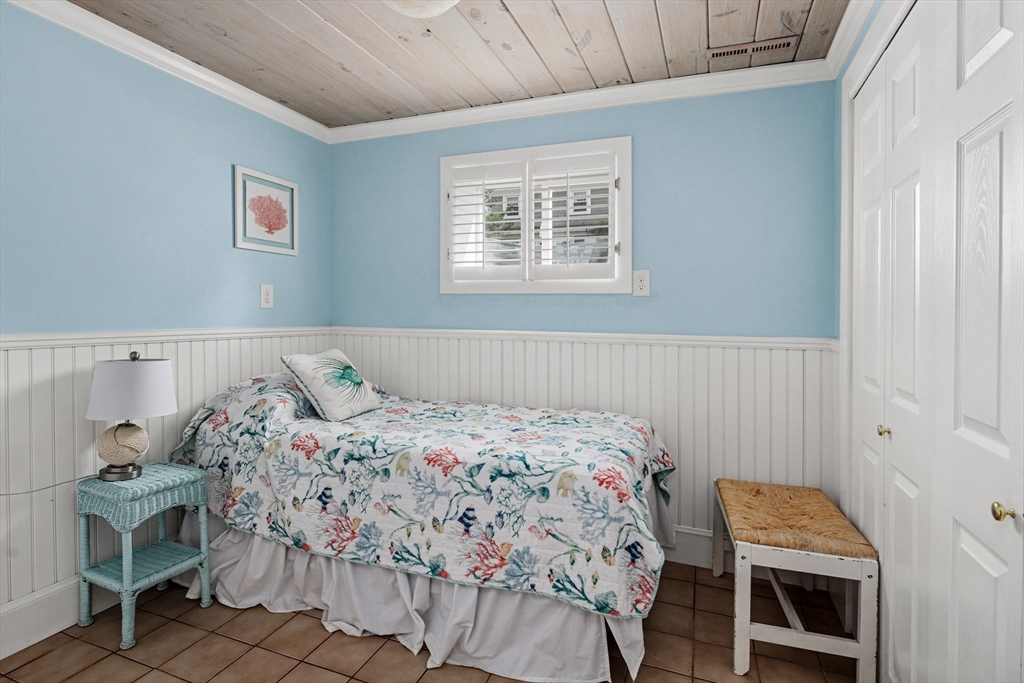 36 Ocean Road North Duxbury, MA 02332 - Photo 22 of 36 a bedroom with a bed and a chair