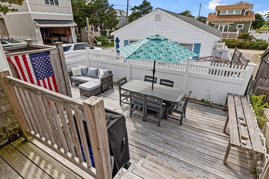 36 Ocean Road North Duxbury, MA 02332 - Photo 24 of 36 a view of a roof deck with table and chairs with wooden floor and fence