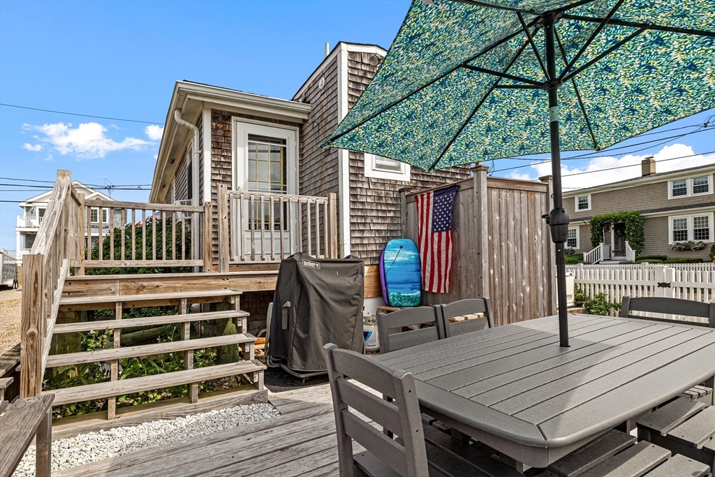 36 Ocean Road North Duxbury, MA 02332 - Photo 25 of 36 a view of a roof deck with table and chairs a barbeque with wooden floor and fence