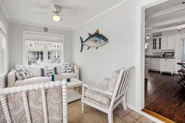 a living room with furniture kitchen view and a window